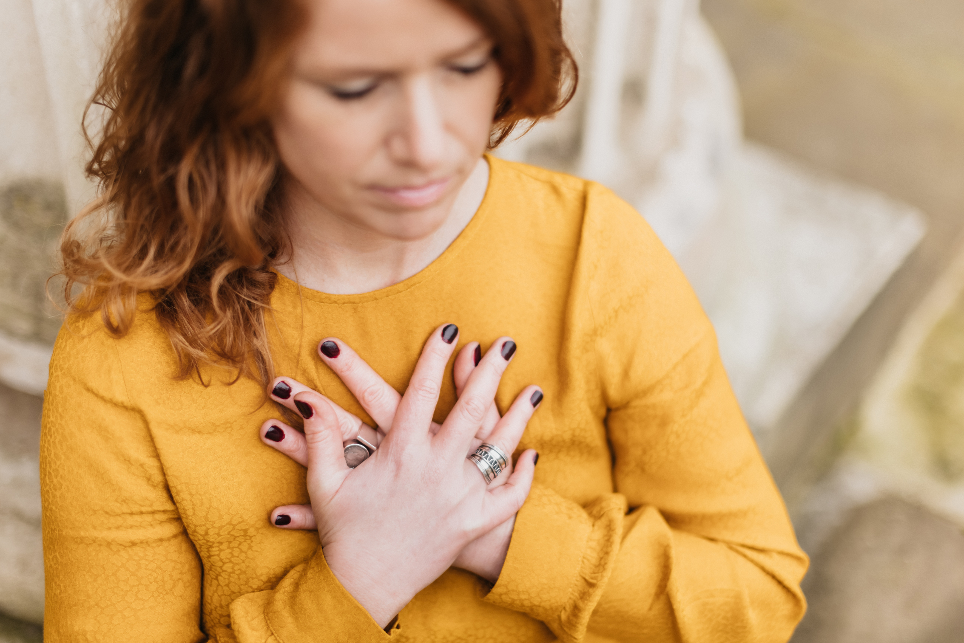 Hands resting gently over the heart